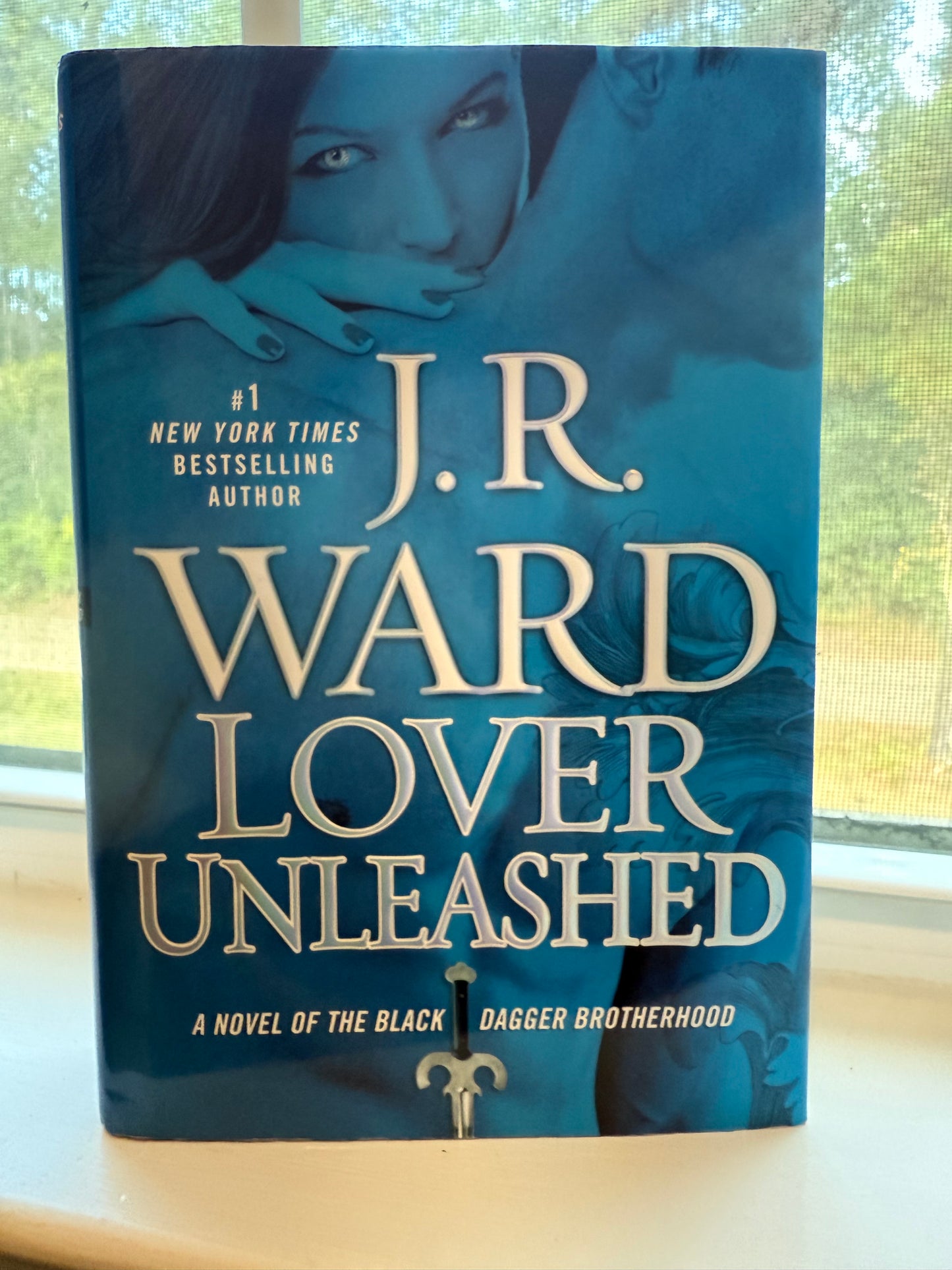 Book titled 'Lover Unleashed' by J.R. Ward on a surface with a blurred background