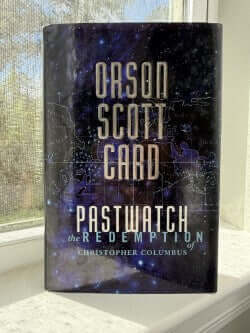 Book titled 'Pastwatch: The Redemption' by Oison Scott Card on a surface with a window in the background.