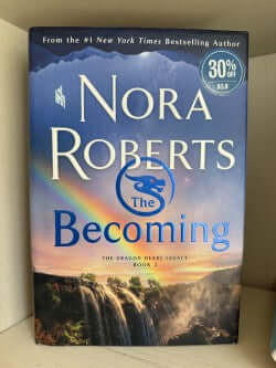 Book titled 'The Becoming' by Nora Roberts with a scenic cover