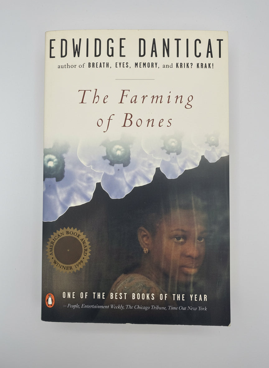 Book cover of 'The Farming of Bones' by Edwidge Danticat on a dark background