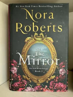 Book titled 'The Mirror' by Nora Roberts with decorative cover