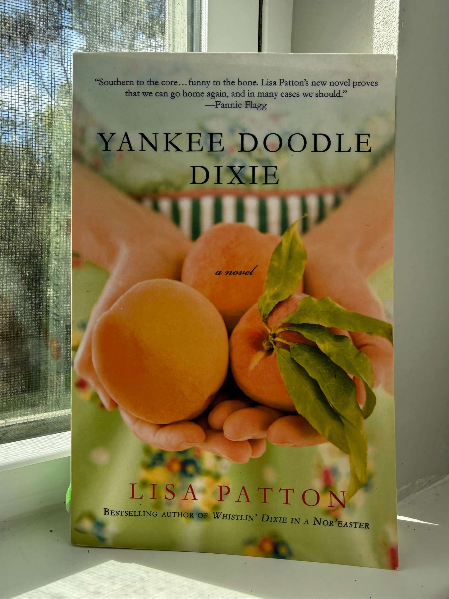 Book cover of 'Yankee Doodle Dixie' by Lisa Patton with peaches on a green background.