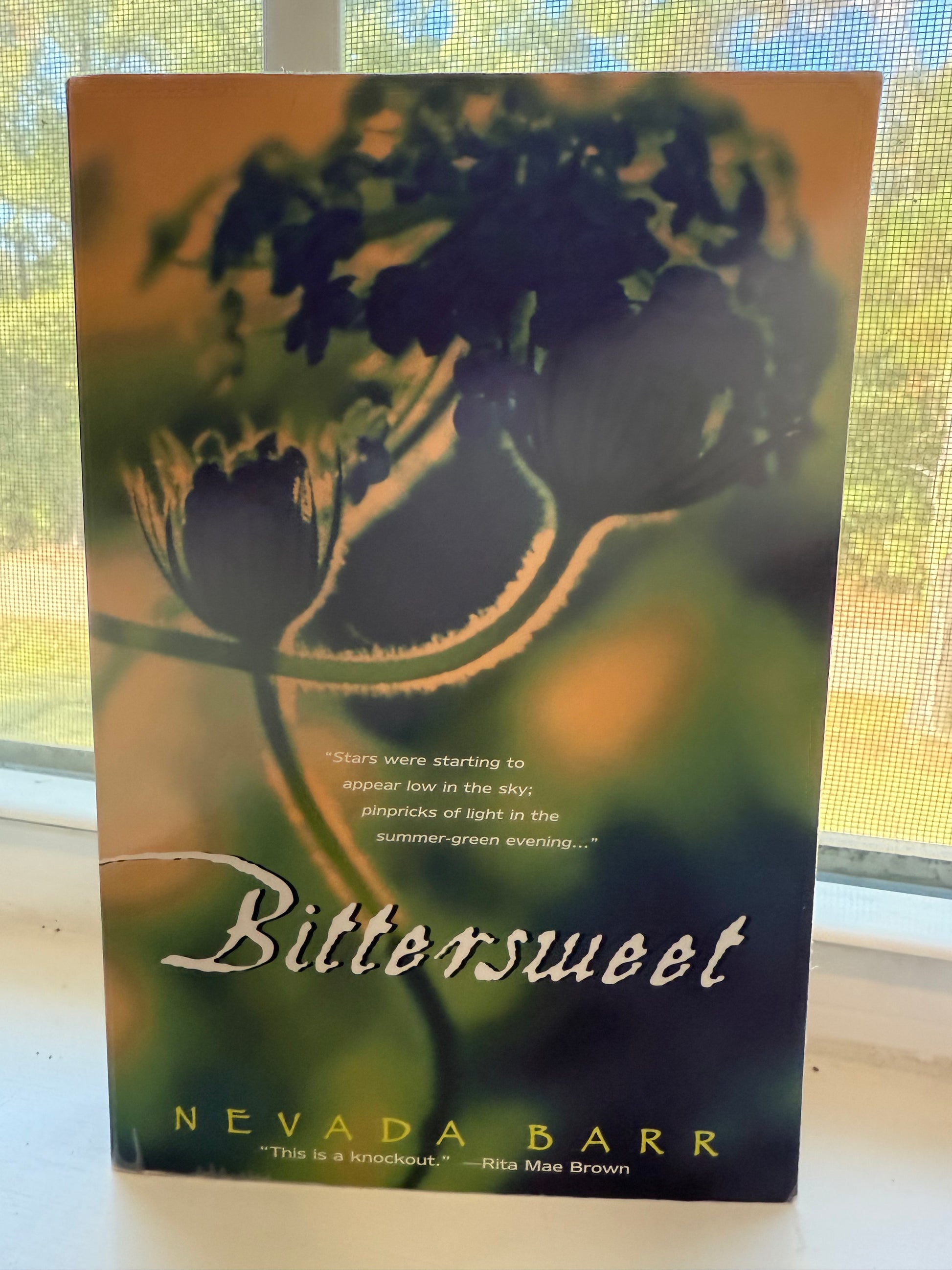 Book titled 'Bitterroot' by Nevada Barr with a butterfly illustration on the cover.
