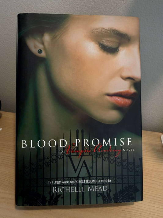 The book cover of 'Blood Promise' by Richelle Mead, featuring a close-up portrait of a woman's face on a dark background with vertical title text.