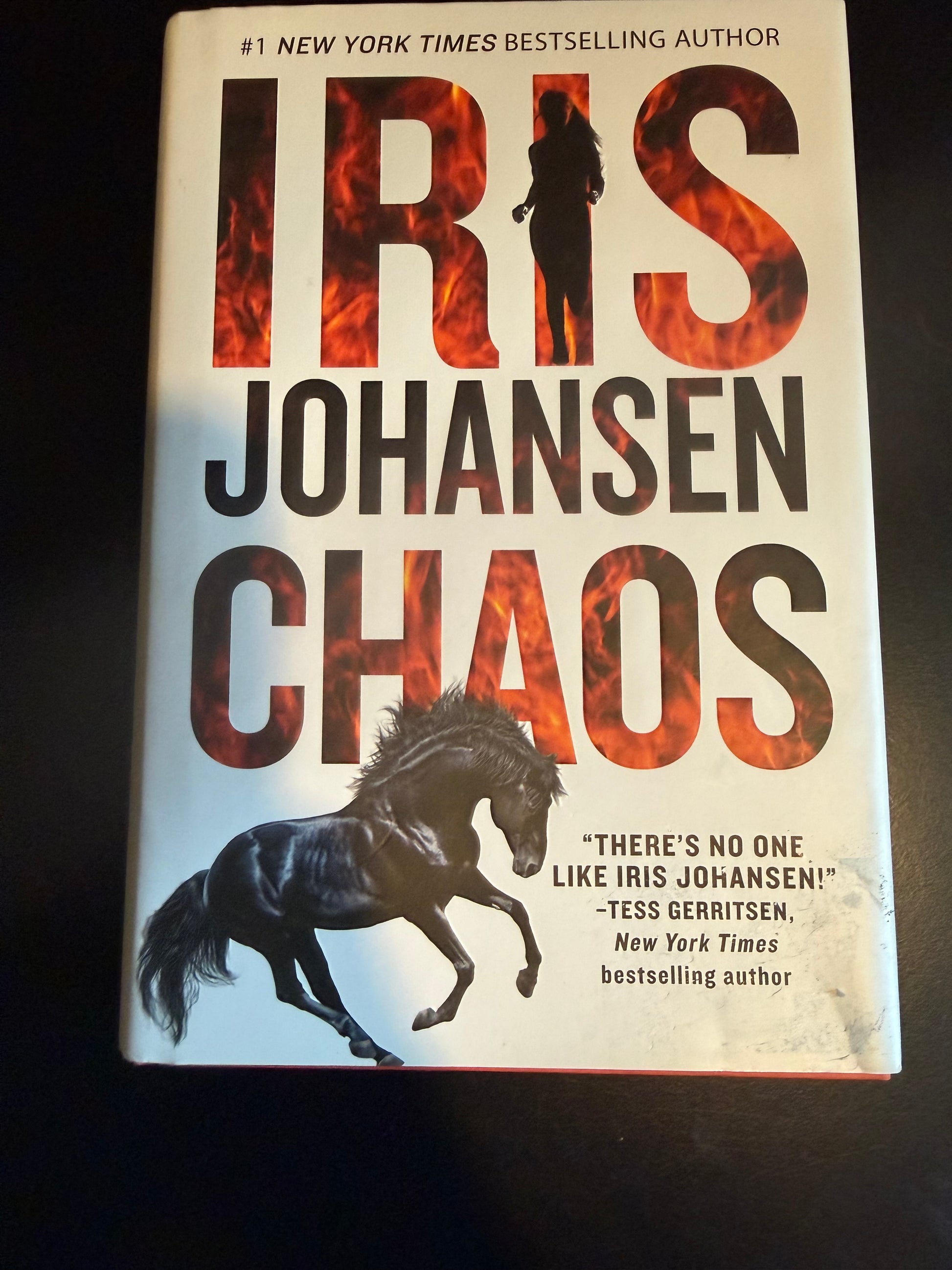 Book titled 'Chaos' by Iris Johansen with a horse illustration on a dark background