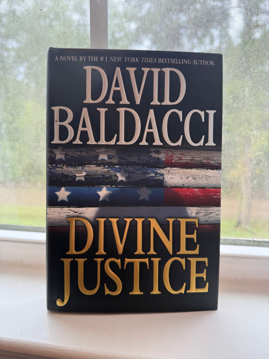 Book titled 'Divine Justice' by David Baldacci with a flag design on the cover.