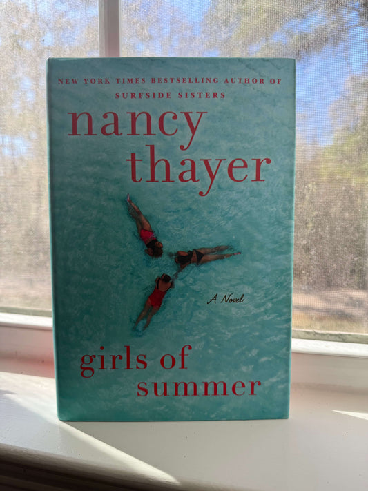 A cover with three women lounging in a pool.