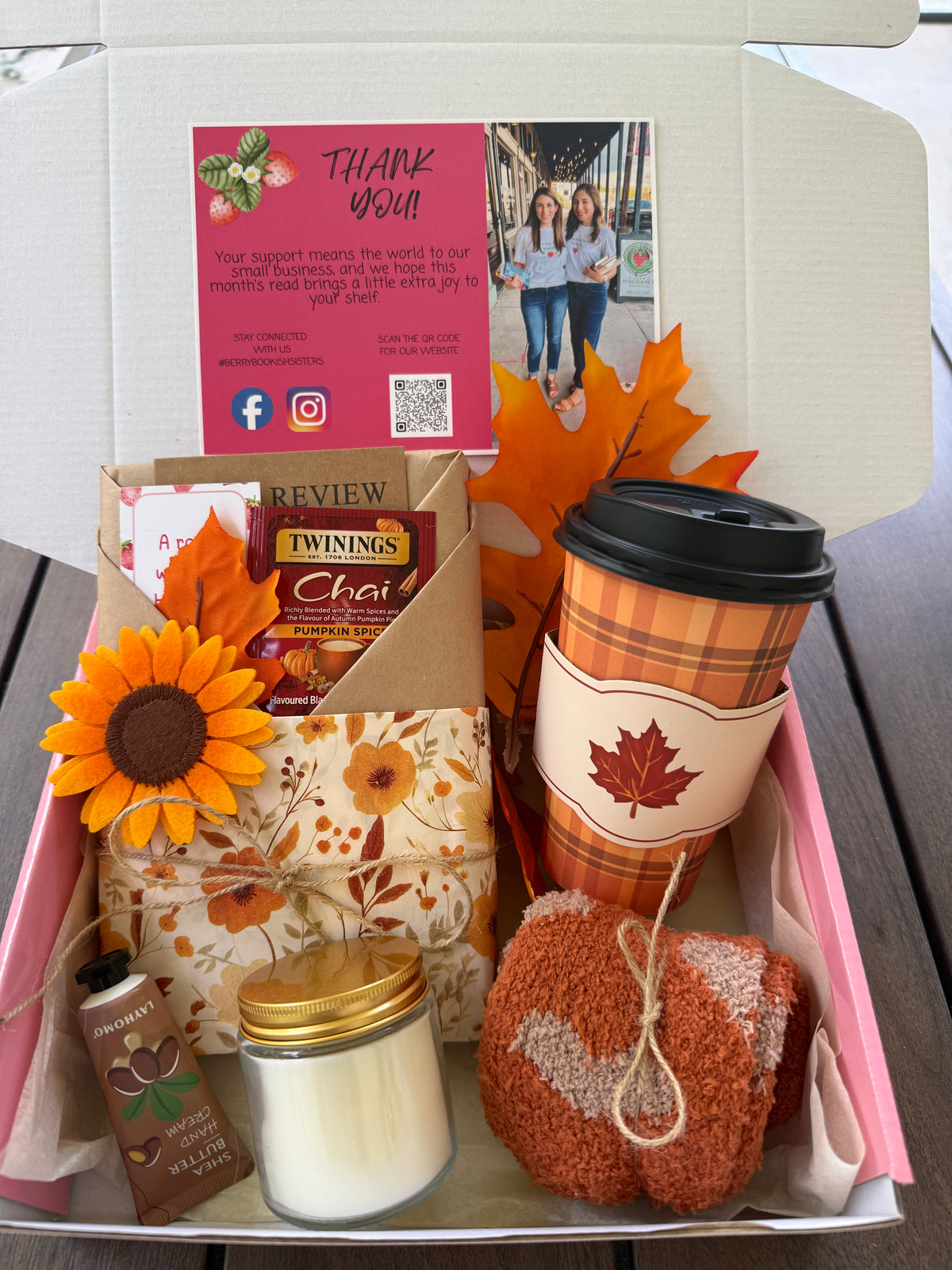 Cozy Up & Read Book Box featuring tea, cozy socks, a candle, and a themed cup in a decorative package.