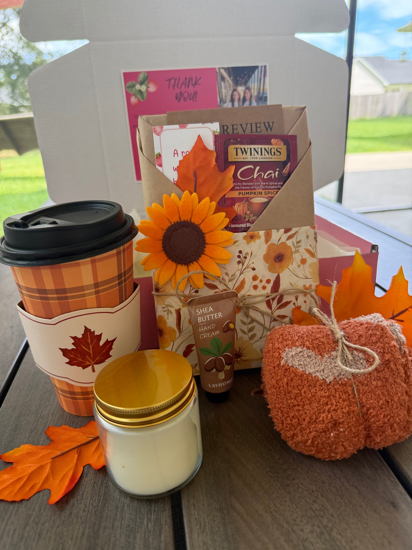 Cozy Up & Read Book Box featuring a coffee cup, candle, tea, lotion, and cozy decorations.