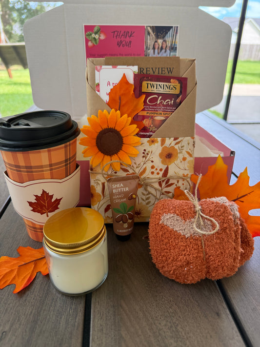 Cozy Up & Read Book Box featuring cozy essentials like tea, lotion, a candle, and pumpkin decor.