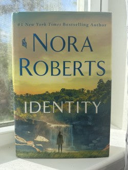 Book titled 'Identity' by Nora Roberts with a scenic cover