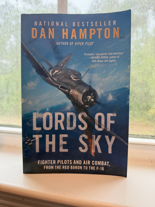 Book titled 'Lords of the Sky' by Dan Hampton with a fighter plane on the cover, placed on a surface.