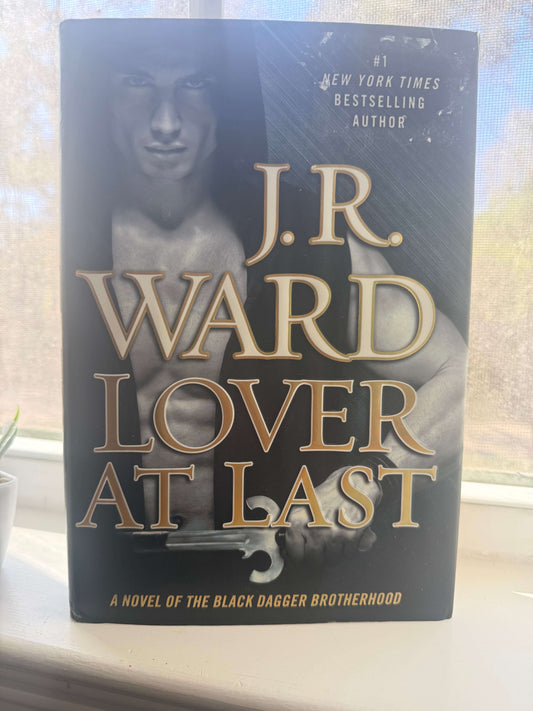 Book titled 'Lover at Last' by J.R. Ward on a windowsill.