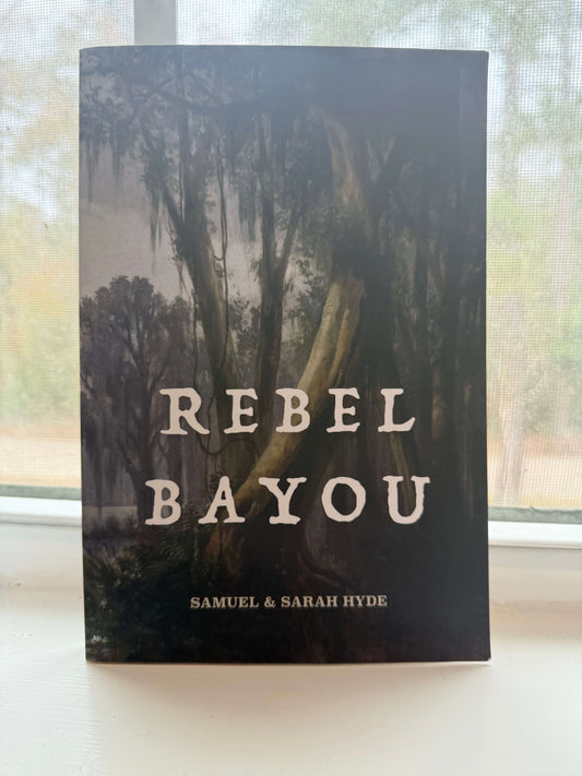Book titled 'Rebel Bayou' by Samuel & Sarah Hyde with a forest cover on a blurred background.