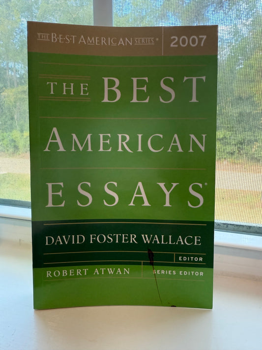 Book titled 'The Best American Essays' on a light background