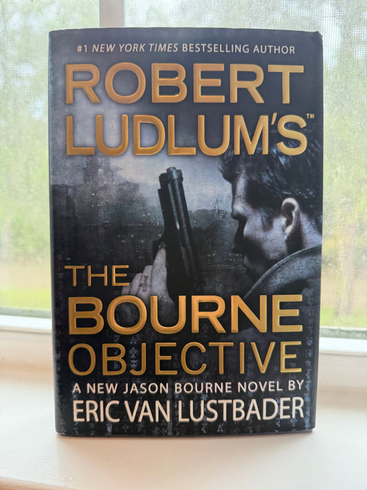 Book titled 'The Bourne Objective' by Eric Van Lustbader on a light background
