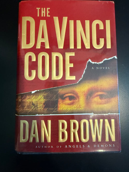 Book cover of 'The Da Vinci Code' by Dan Brown on a dark background