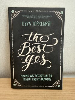 Book titled 'The Best Yes' by Lysa TerKeurst on a wooden surface with a neutral background