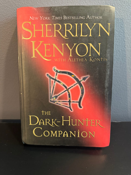 Book titled 'The Dark-Hunter Companion' by Sherrilyn Kenyon on a gray surface
