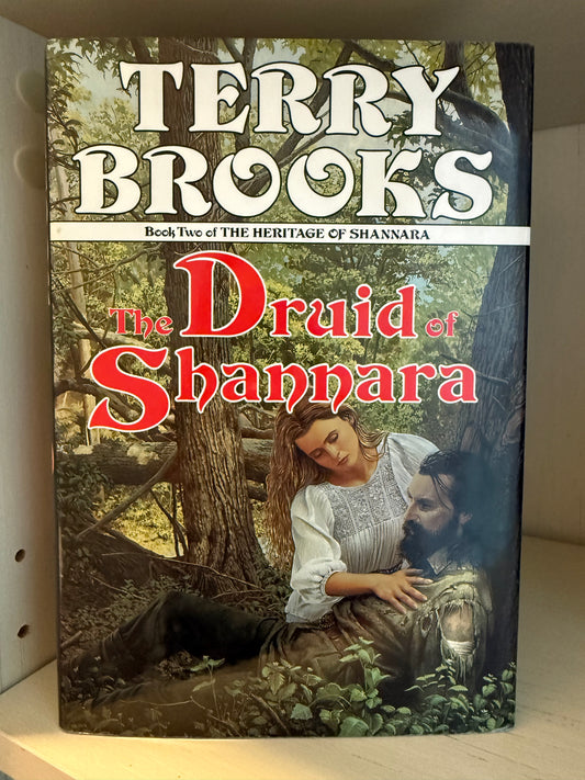 A cover with a woman and man underneath a tree. 