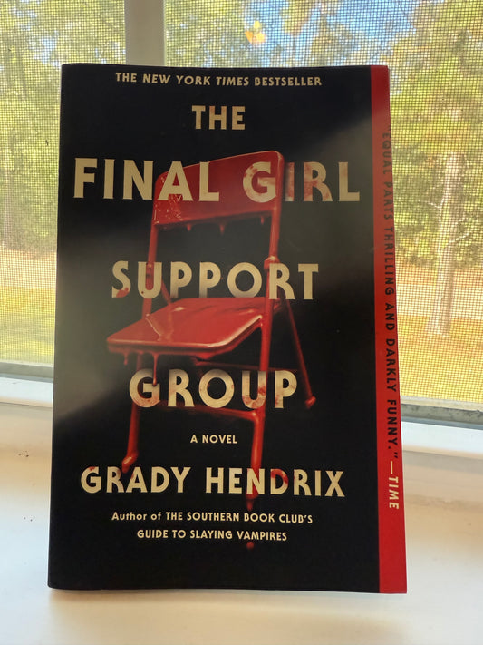 Book titled 'The Final Support Group' by Grady Hendrix on a surface with a window in the background.