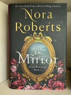 Book titled 'The Mirror' by Nora Roberts with decorative cover
