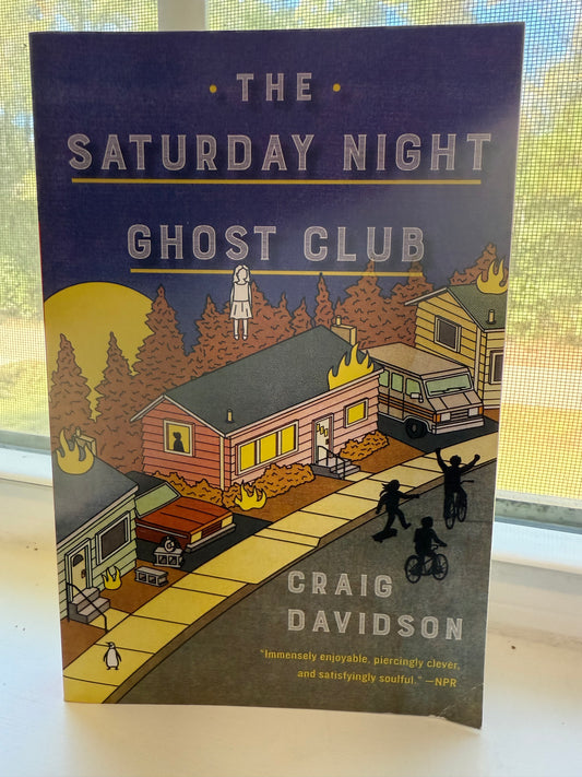 Book cover of 'The Saturday Night Ghost Club' by Craig Davidson on a white surface.