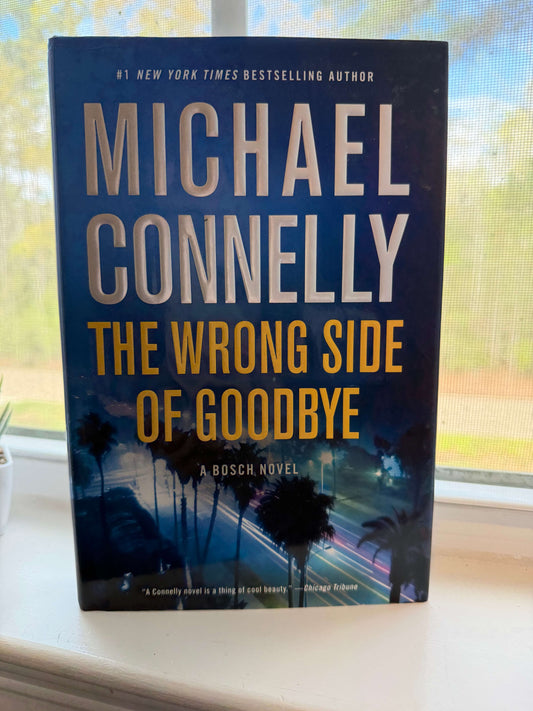 Book titled 'The Wrong Side of Goodbye' by Michael Connelly on a windowsill.